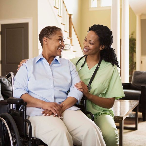 Nurse caregiver with elderly patient at home